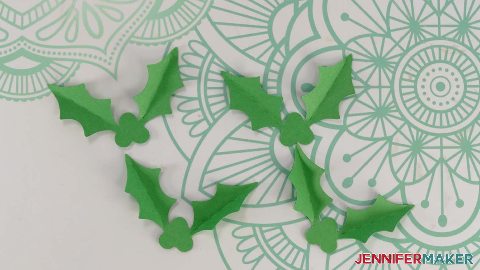 Folded holly leaf pieces for the Santa purse gift bag.