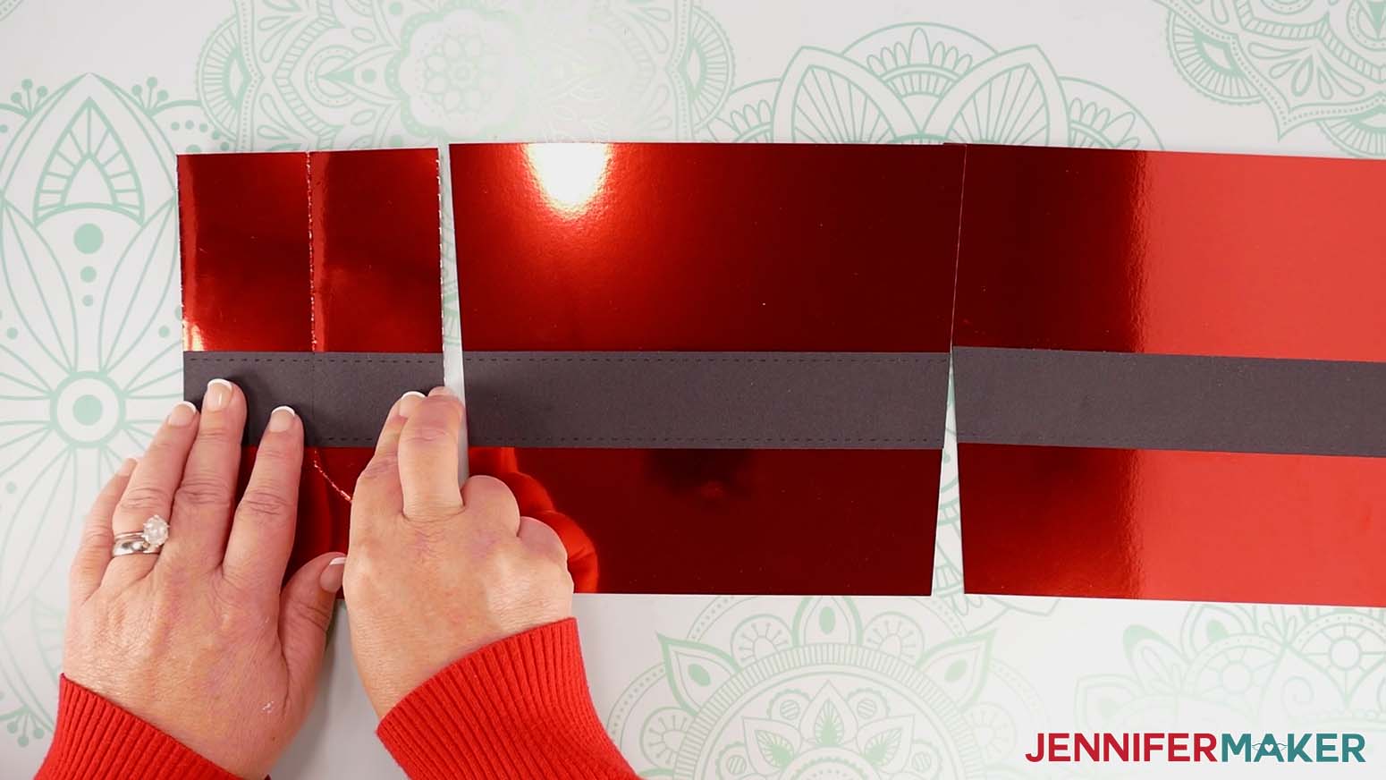 Position the strap piece on the Santa purse&rsquo;s side, aligning its top with the top of the strap on the front piece, with the strap&rsquo;s vertical crease aligned with the side&rsquo;s vertical crease.