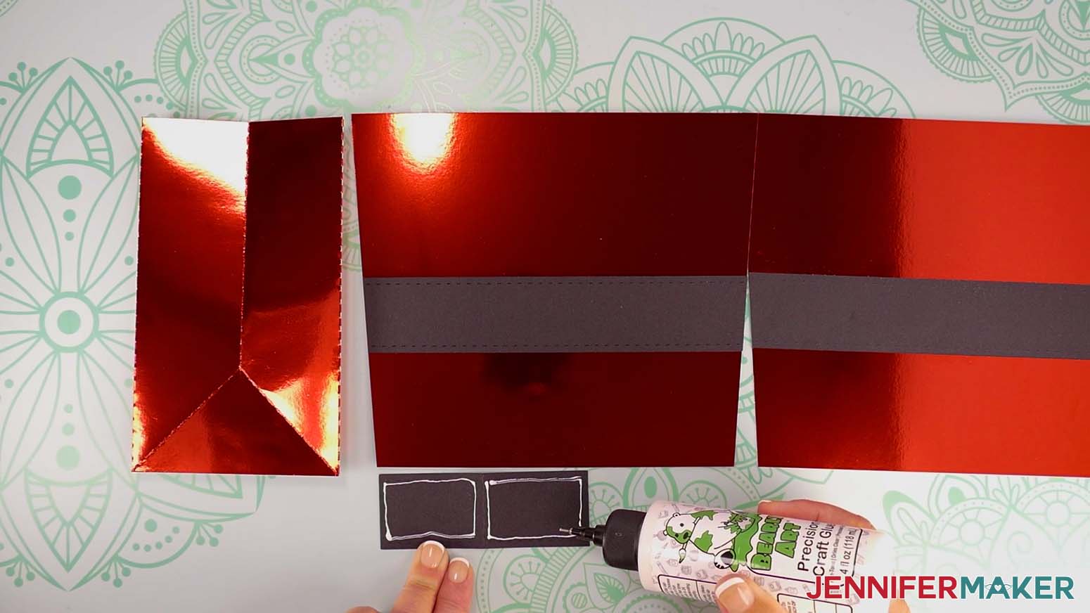 Apply a thin line of craft glue around the inside edges of the left and right halves of the strap for the Santa purse gift bag.