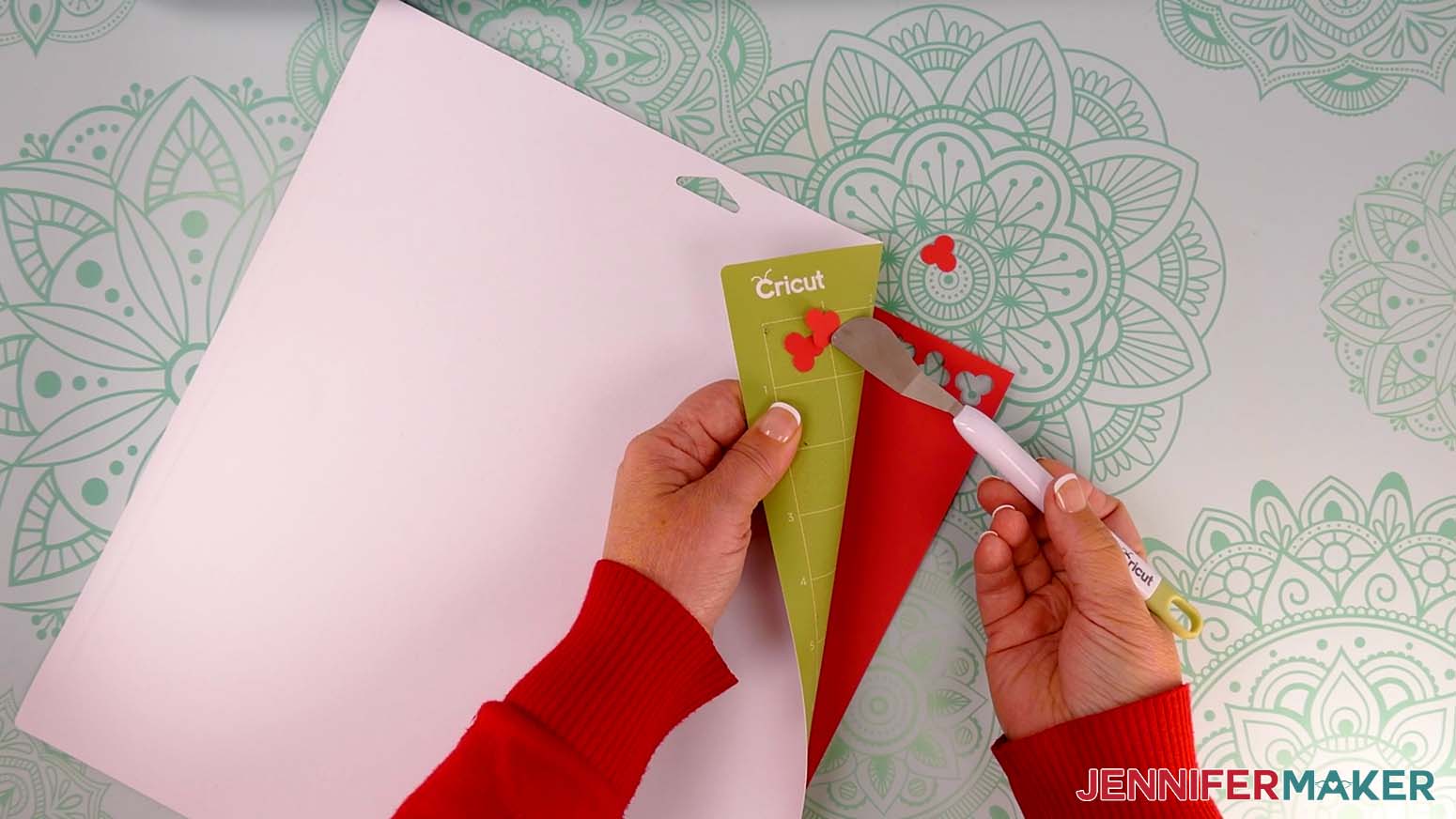 Use a spatula to help lift delicate holly berry pieces off the Cricut machine mat.