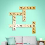 Scrabble tiles wall art with light wood tiles and black vinyl in a living room