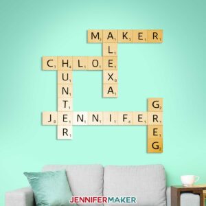 Scrabble tiles wall art with light wood tiles and black vinyl in a living room