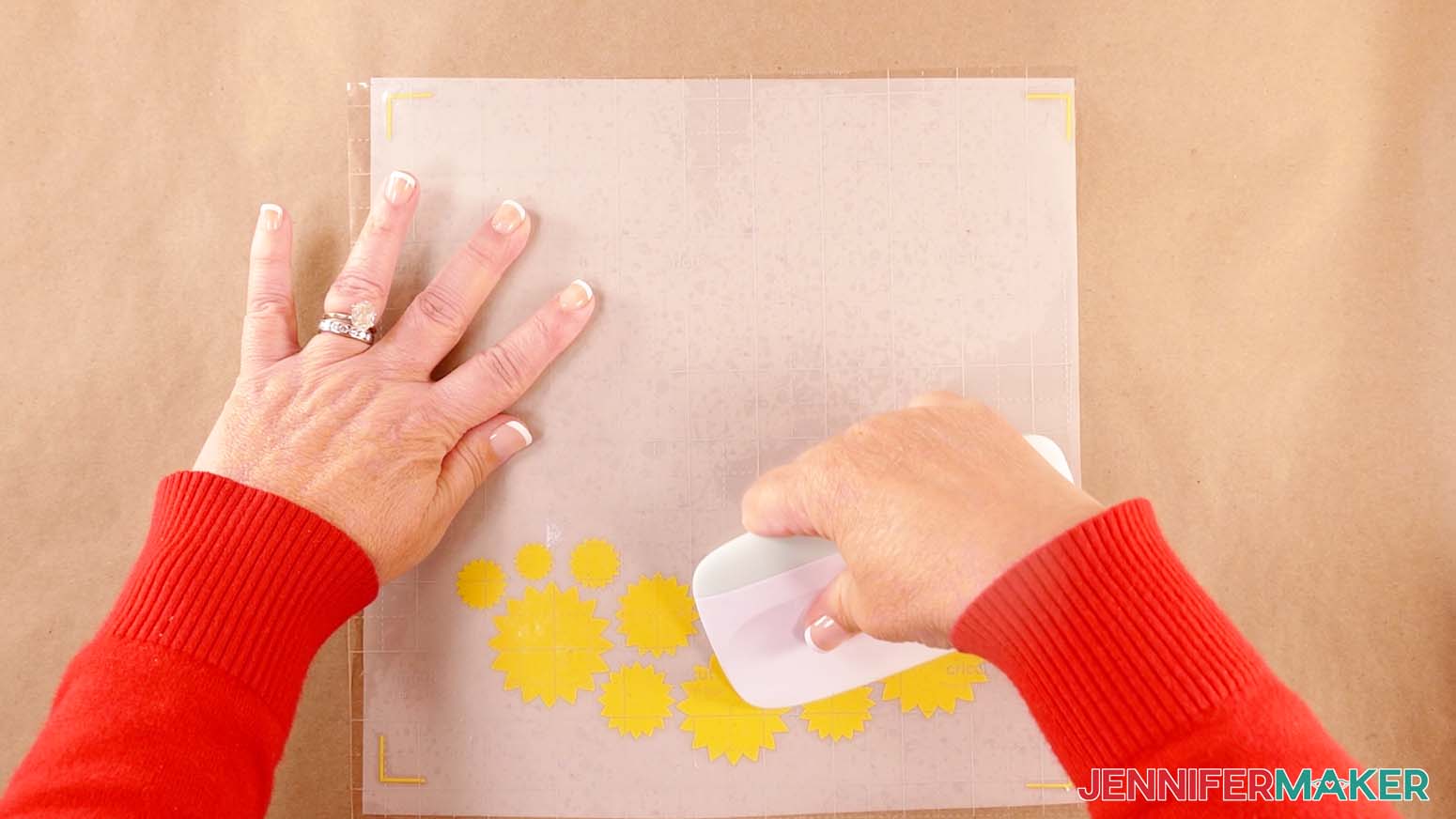 Use a scraper to burnish the transfer tape onto the vinyl to make a shadow box with floating pieces