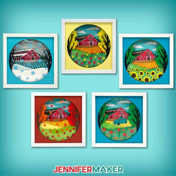 Learn how to make a shadow box with floating pieces with JenniferMaker's step-by-step tutorial! Five shadow boxes with layered cardstock depicting a red farmhouse sit on a blue backdrop. The boxes show winter, spring, summer, and autumn at the farm, plus an extra box with birds and truck near the farmhouse.