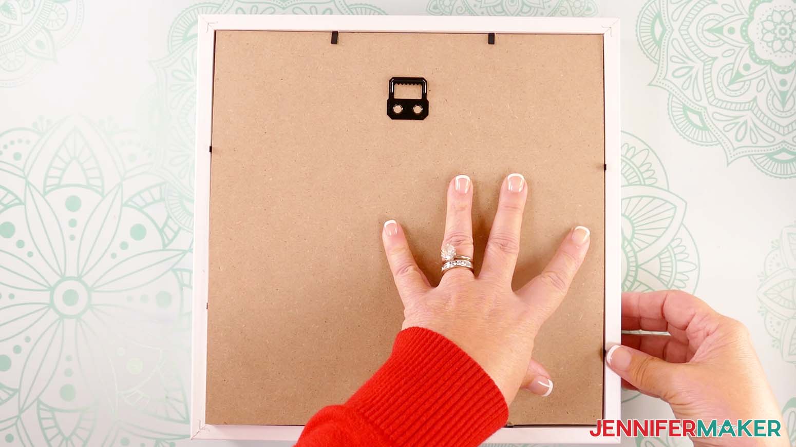 Secure the back of the shadow box after assembling a shadow box with floating pieces