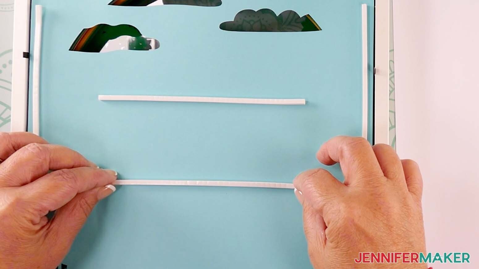 Add foam tape to the back of layer fourteen to make a shadow box with floating pieces