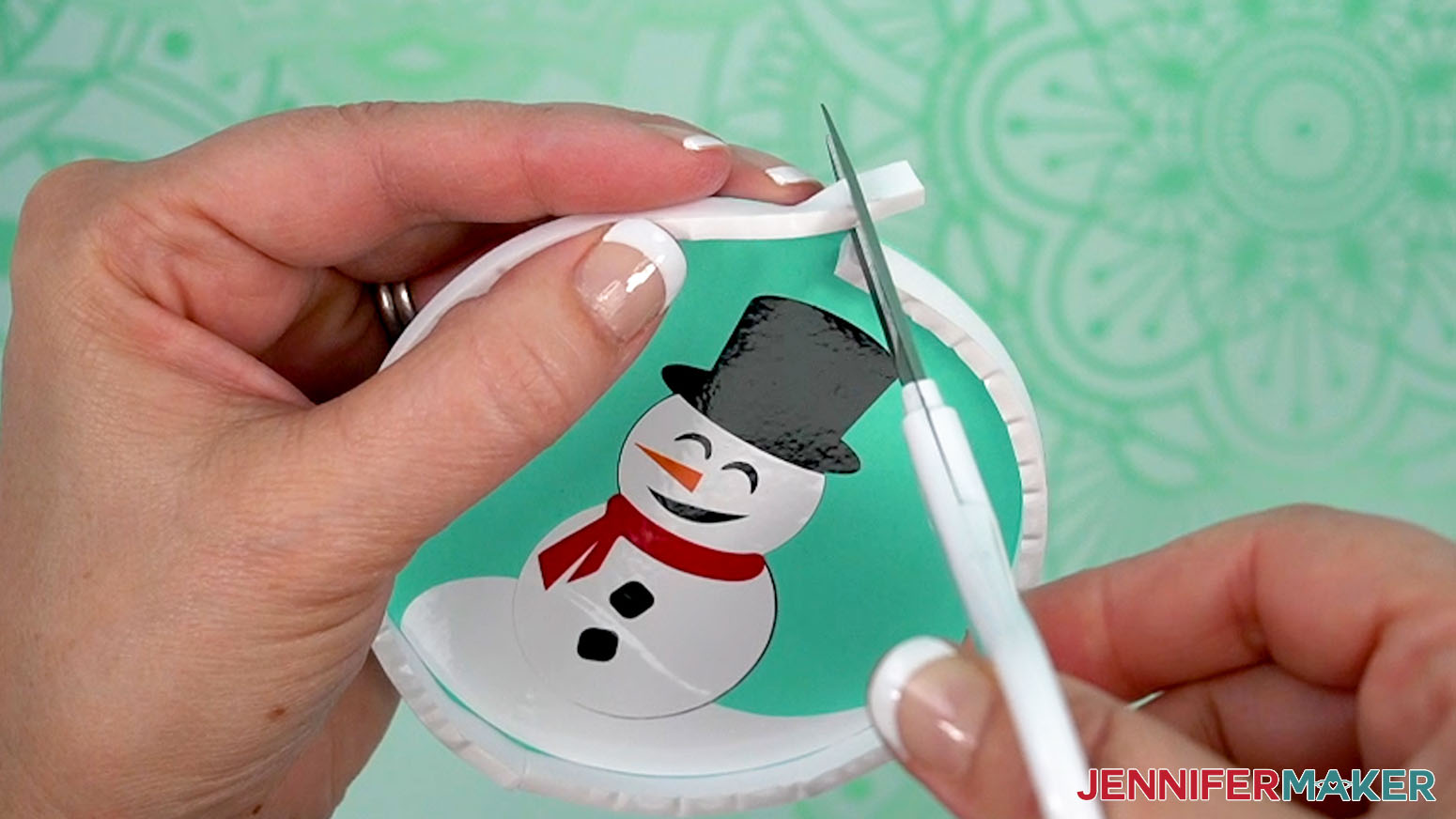 Cutting excess adhesive tape with scissors