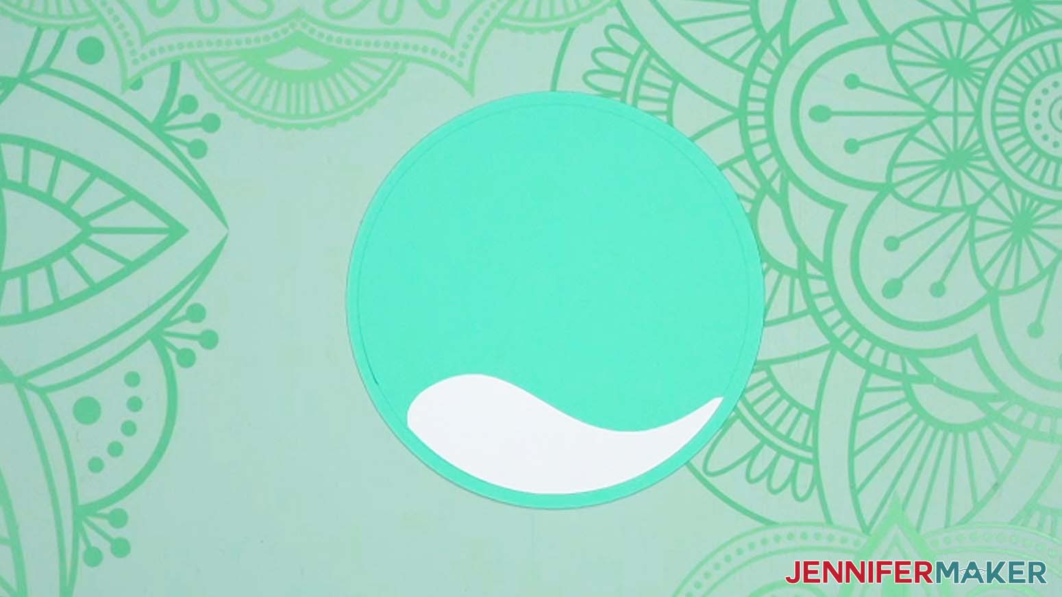 White vinyl applied to teal circle