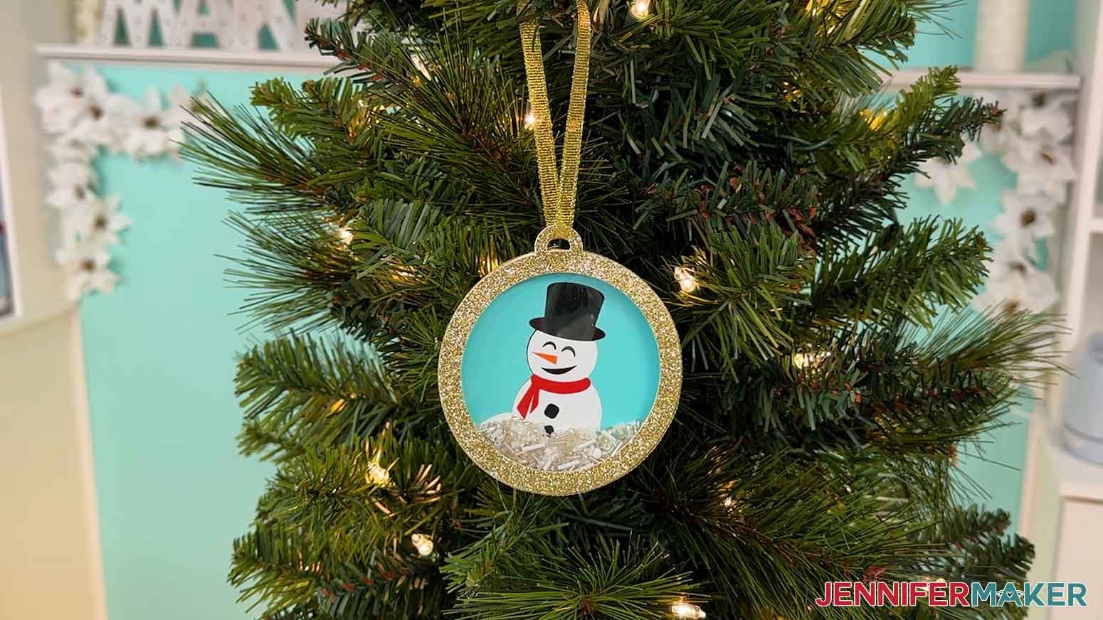 Snowman shaker ornament hanging on Christmas tree
