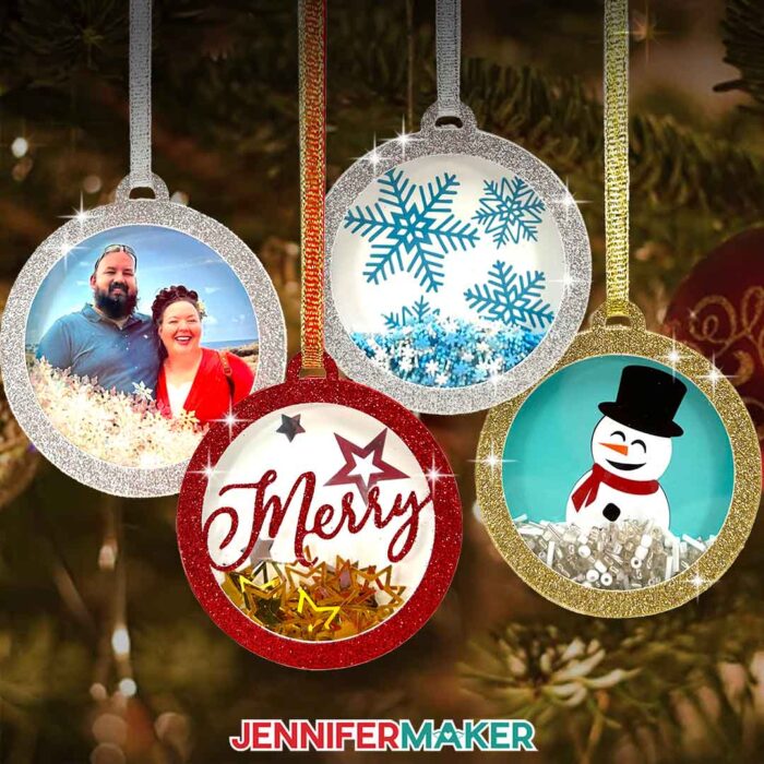 Learn how to make holiday shaker ornaments with Jennifer Maker's tutorial! Four round, glitter-framed cardstock ornaments with acetate front covers and vinyl backdrops depicting winter themes hang from a tree by ribbon. Each ornament has shiny confetti inside. One ornament has a photo of Jennifer and her partner.