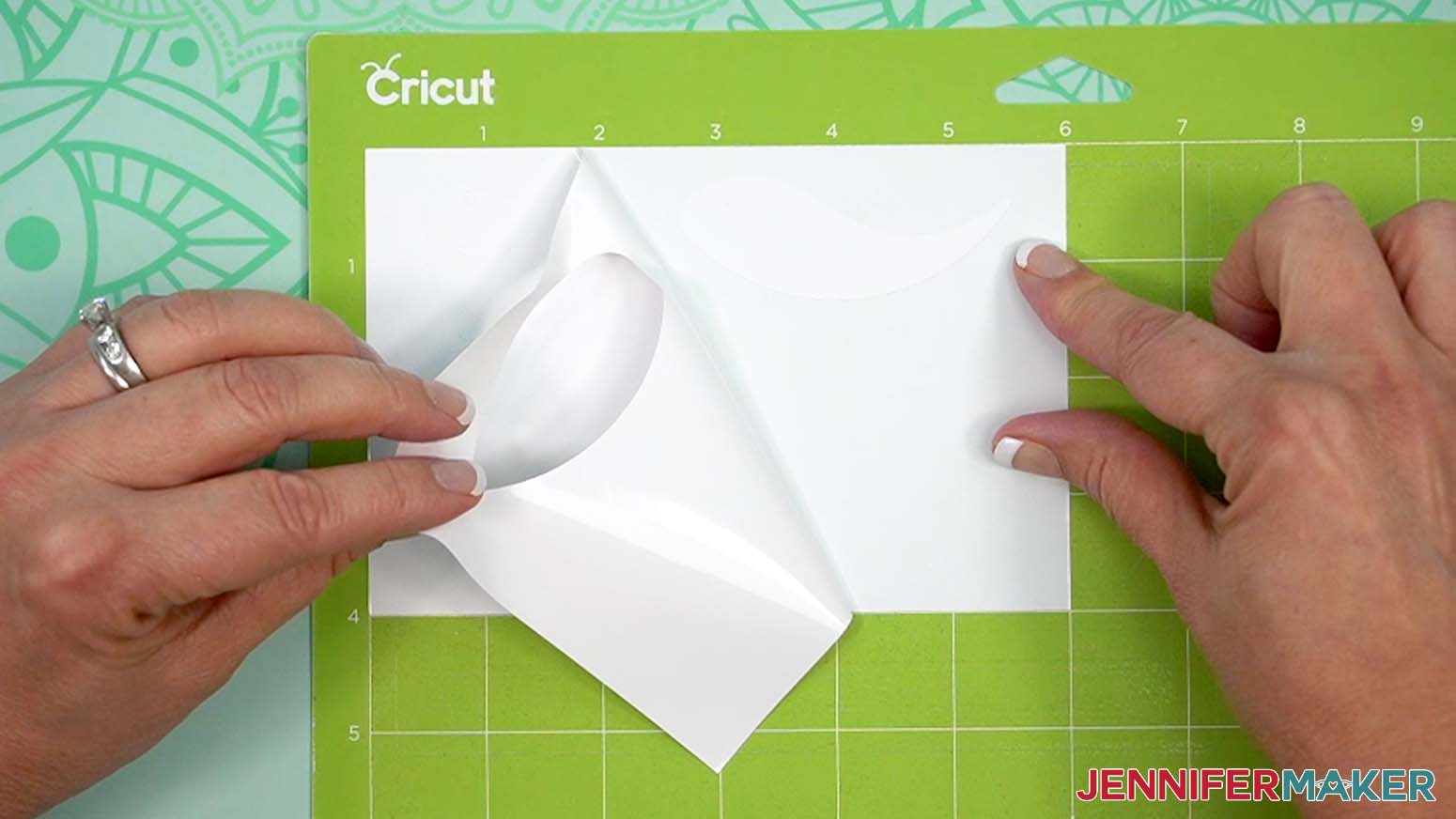 keep the vinyl on your mat and use your weeding tool to carefully peel away the extra background vinyl.