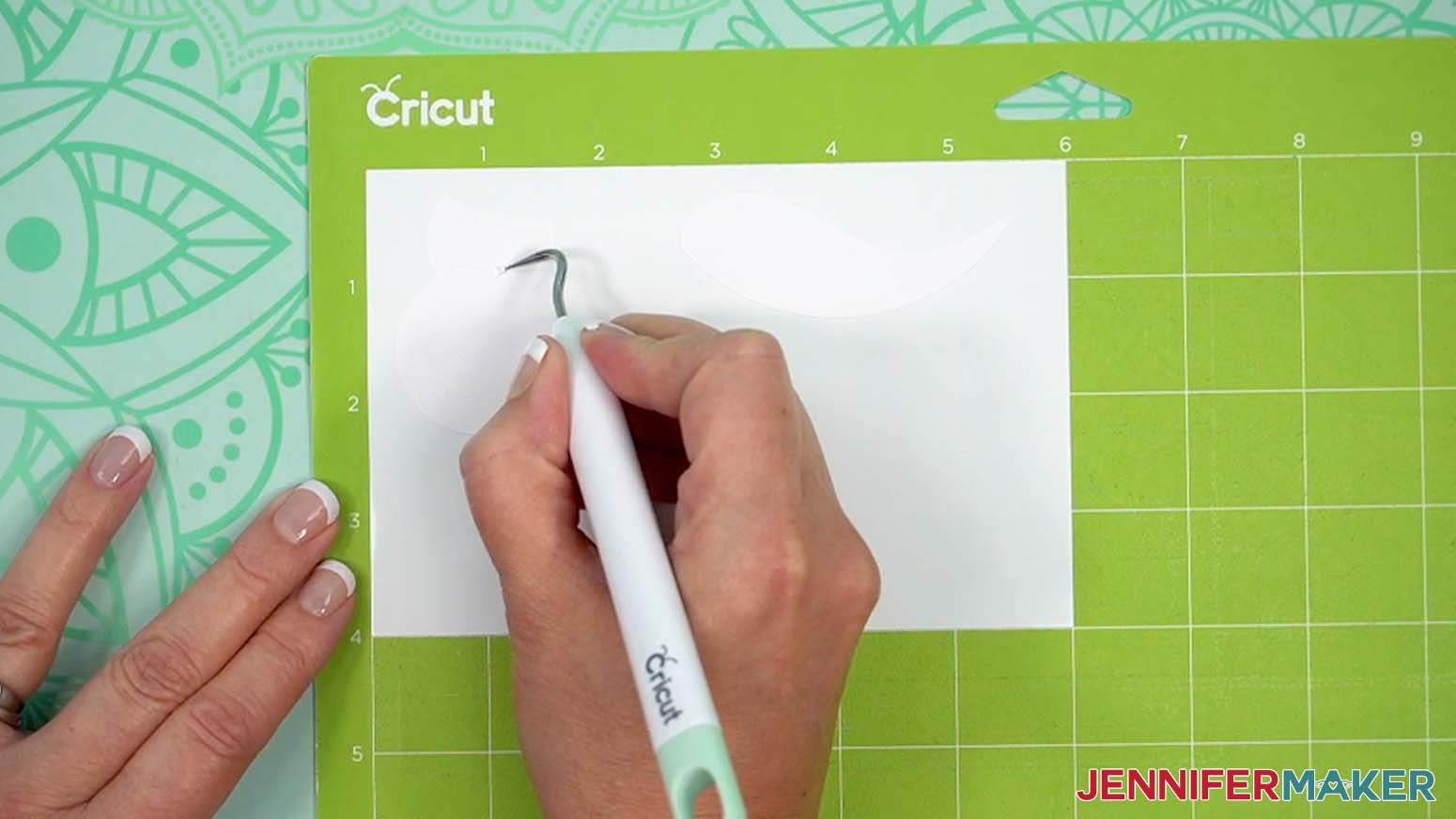 keep the vinyl on your mat and use your weeding tool to carefully peel away the extra background vinyl.
