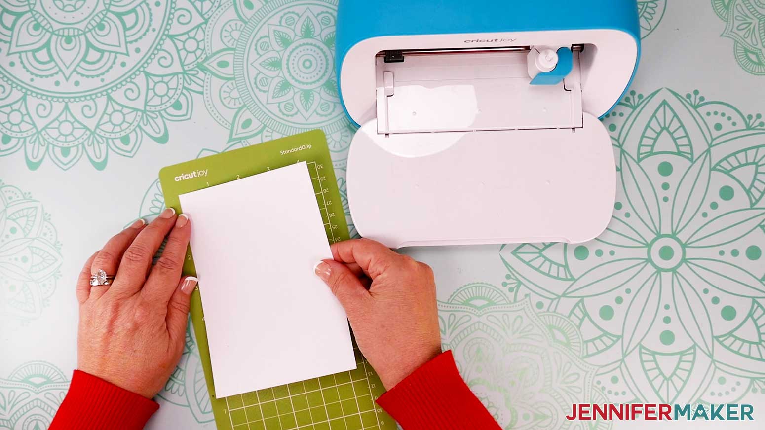Prepare your green StandardGrip Joy mat for cutting by adhering the cardstock to the top left corner