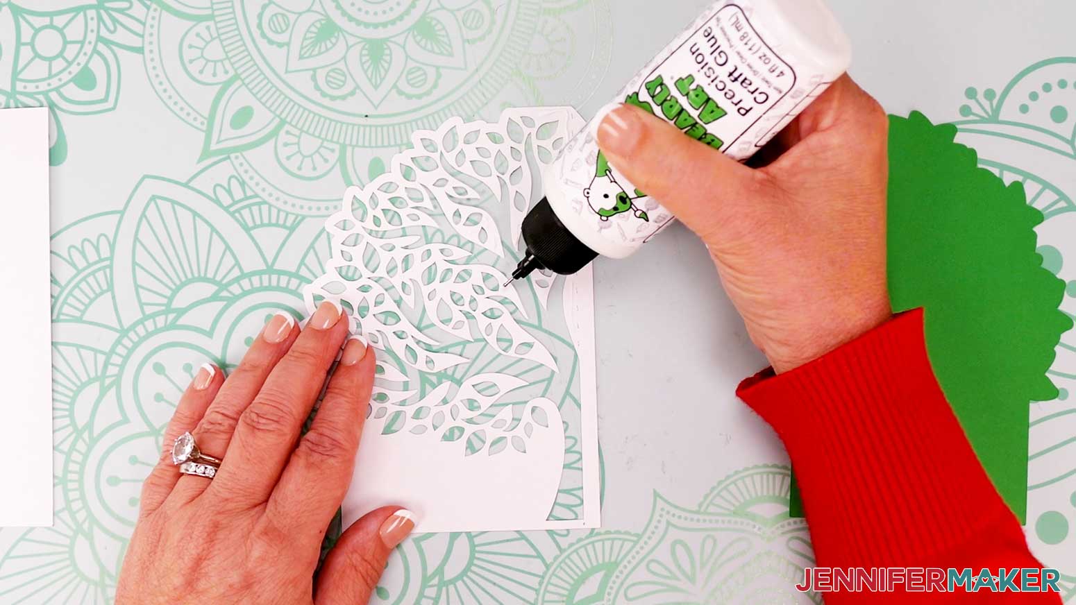 Use a precision glue tip to apply glue in between the cutouts of the front panel for the tree shaped edge card