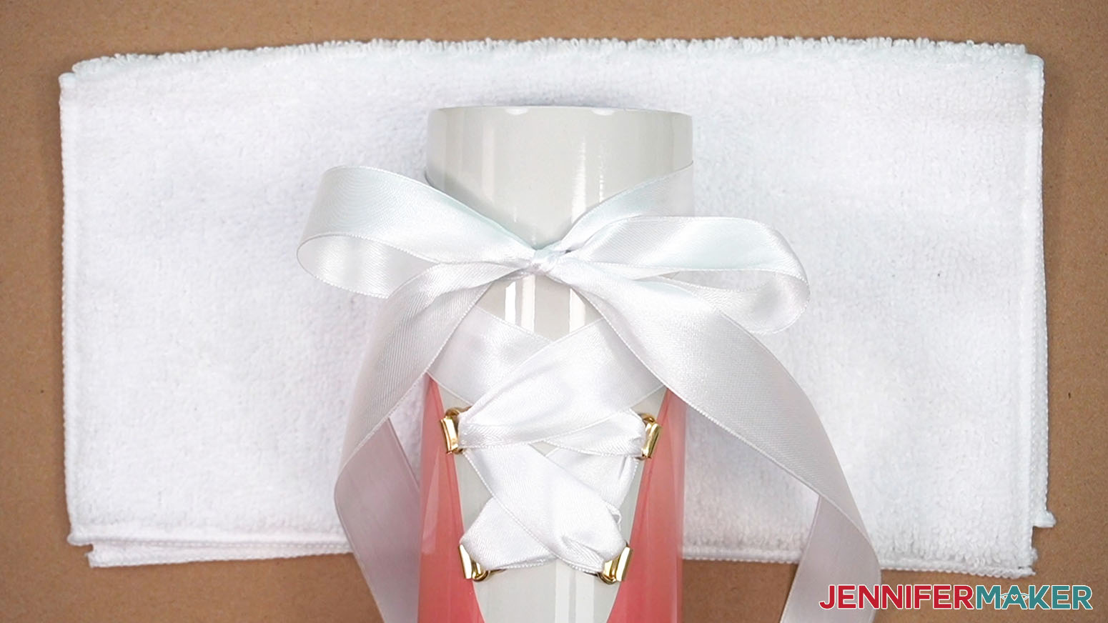 Bring the ribbons back to the front of the tumbler and tie in a bow.