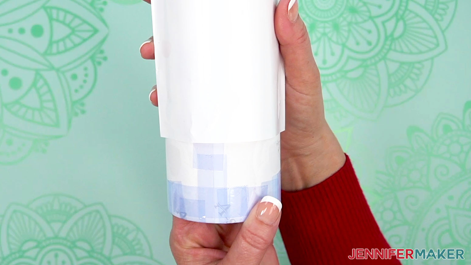 Place the shrink wrap over the taped tumbler design.