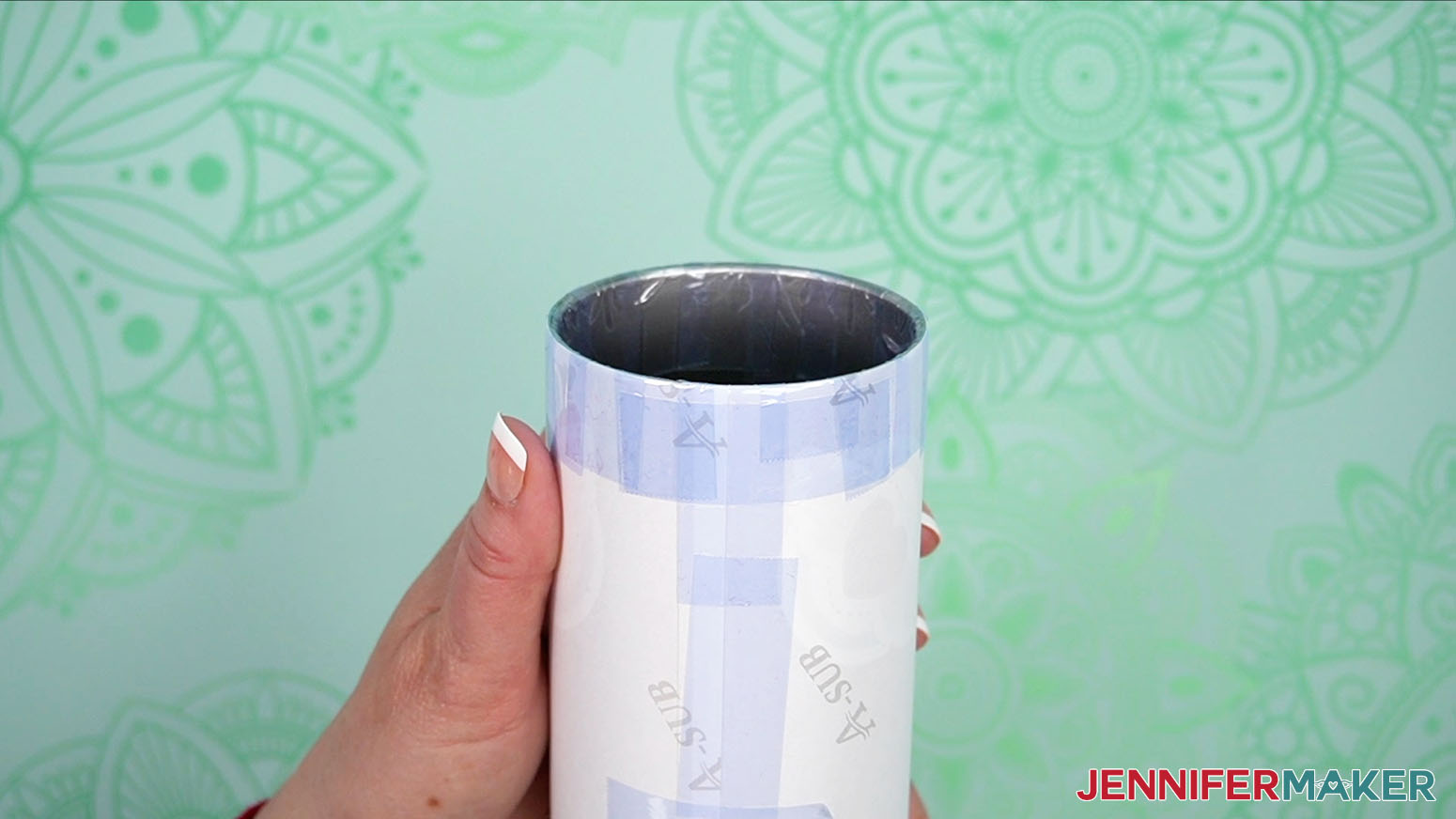 Secure the design to the tumbler by making sure it is taped all the way around the edges of the design.