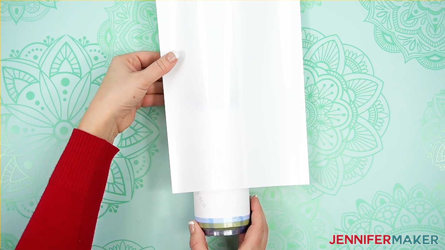 Put tumbler inside shrink wrap sleeve
