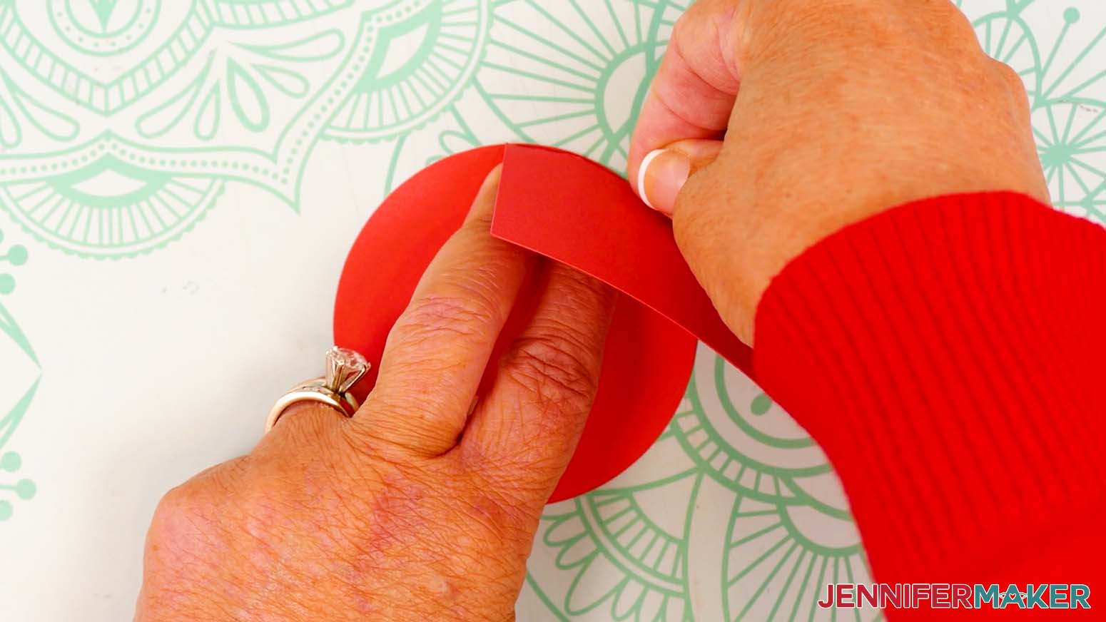 Line up the two glued tabs’ on the bottom circle piece, keeping the crease lines flush along the curved outer perimeter.