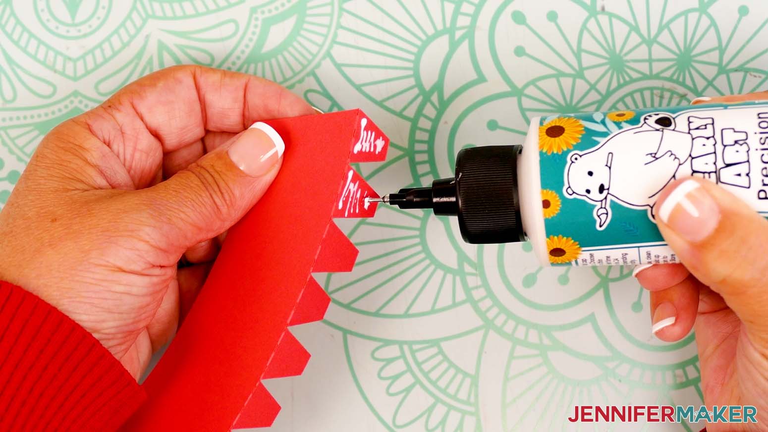 Add a small amount of craft glue to the outside of the base piece’s first two tabs.