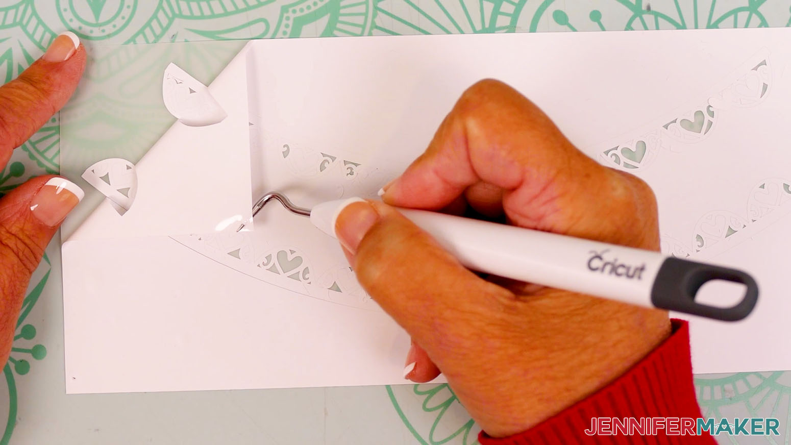 Use a weeding tool to remove the larger pieces of vinyl from the snow globe gift box decal.