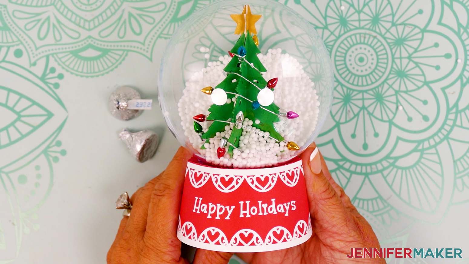 The finished snow globe gift box with a red base and cardstock tree inside.