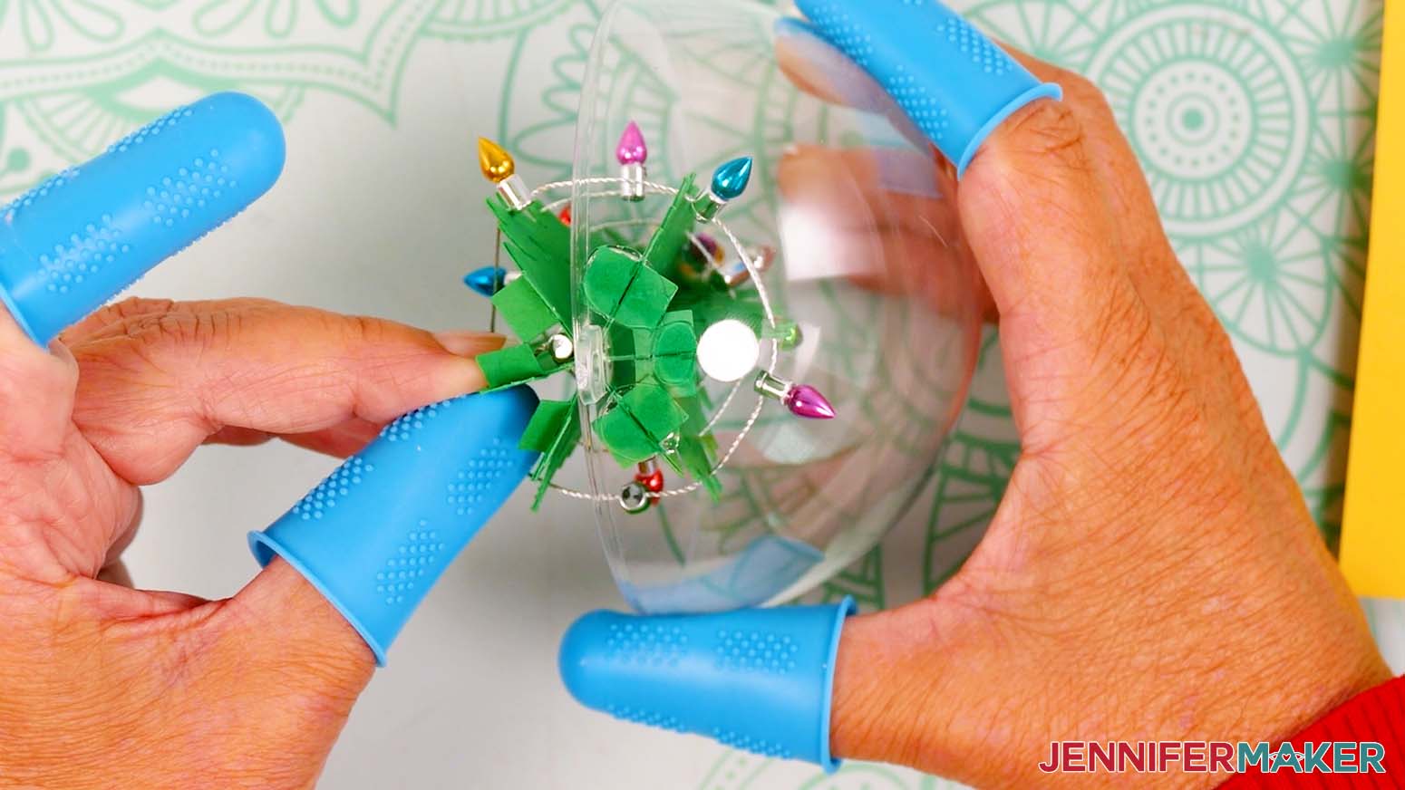 Hold the tree and globe pieces together firmly until the hot glue sets.