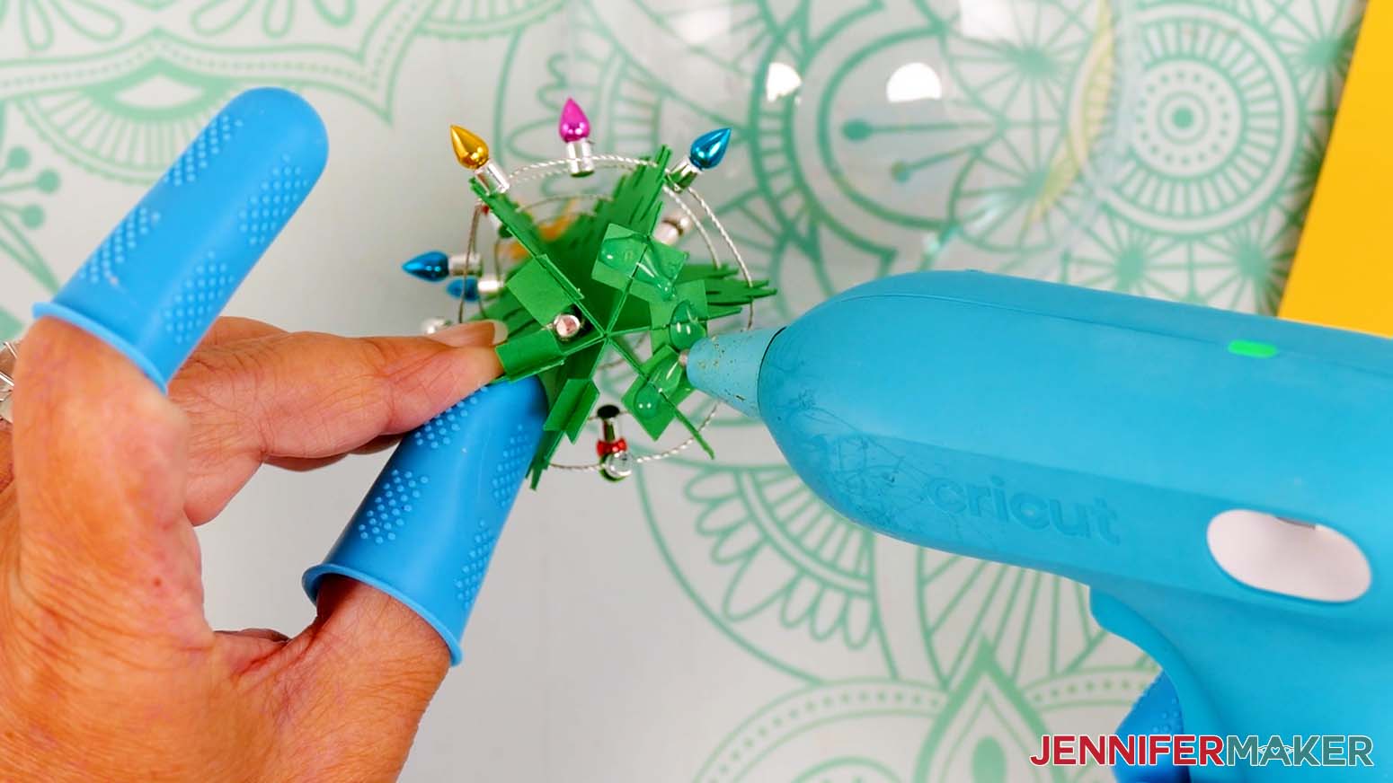 Add hot glue to the bottom of the tree's tabs.