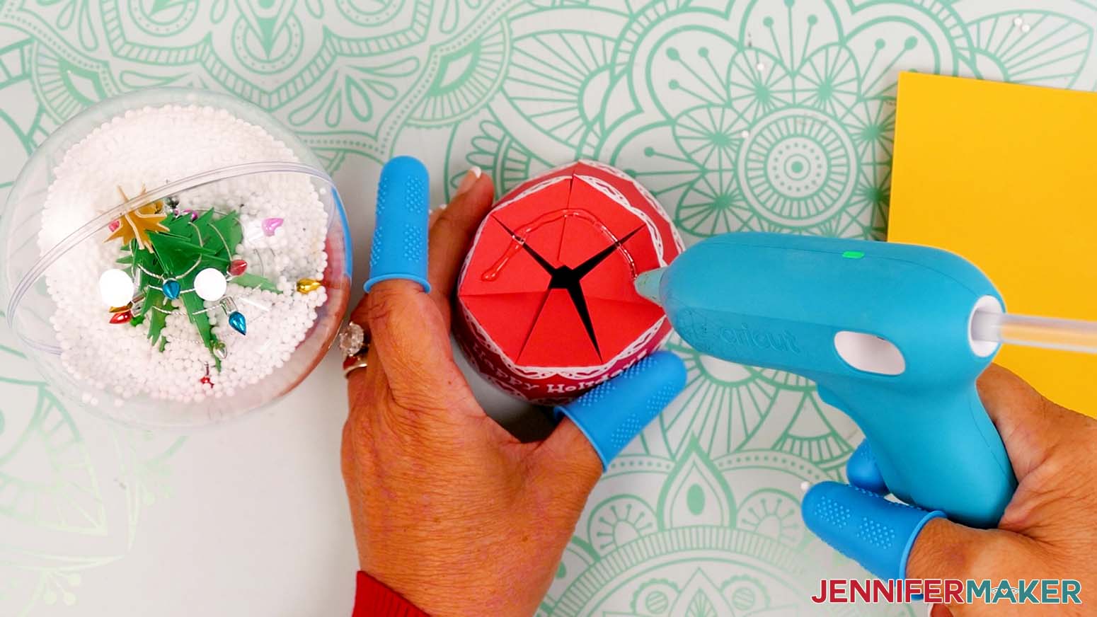 Add hot glue to the top of all of the snow globe gift box lid’s tabs.