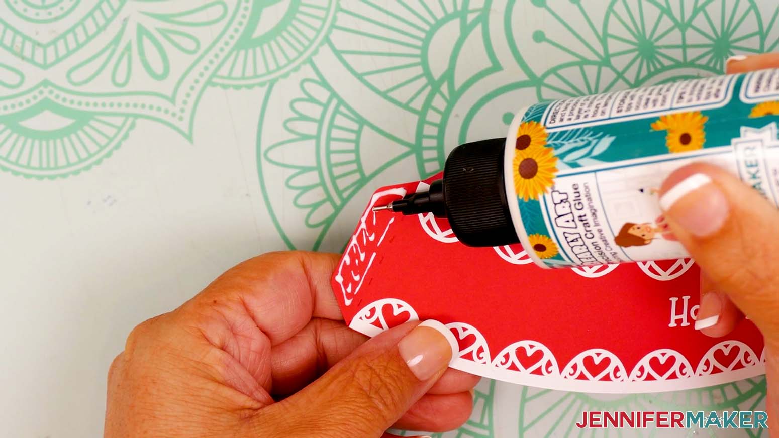 Add craft glue to the snow globe gift box lid's side tab, on the side with the vinyl.