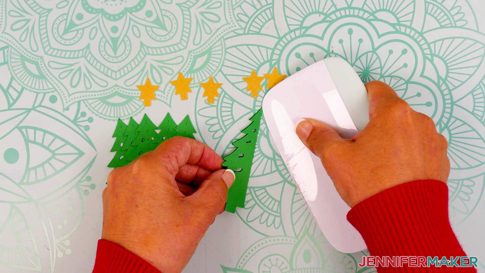 Fold the first tree piece in half along the center crease line, then sharpen the fold with a scraper tool.