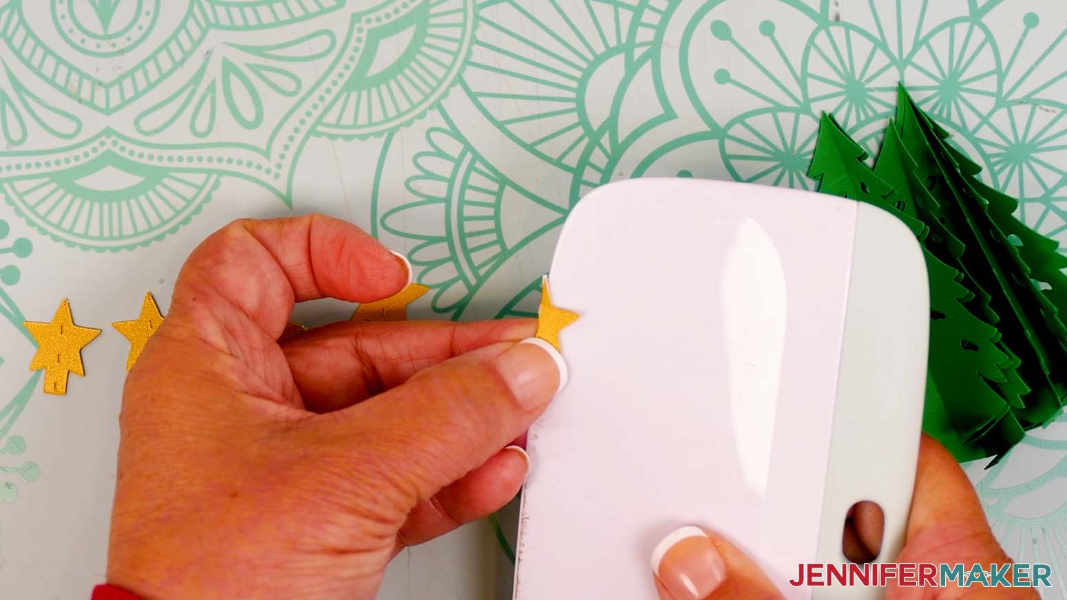 Place the edge of a scraper tool along the star's crease line to help fold it in half.