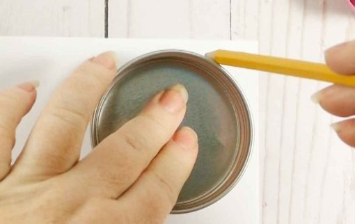 Trace the lid of the Mason jar onto a piece of paper with a pencil