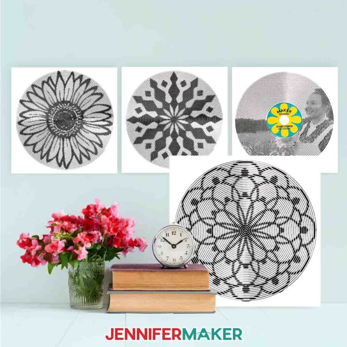 Several white canvases with intricate black cut vinyl designs made with Spiral Betty.