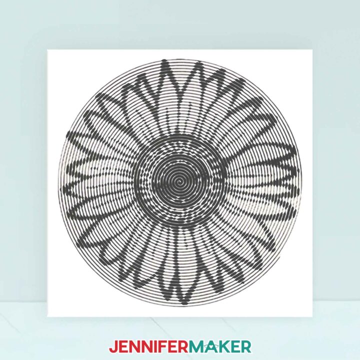 A white canvas with an intricate sunflower cut vinyl design made with Spiral Betty.