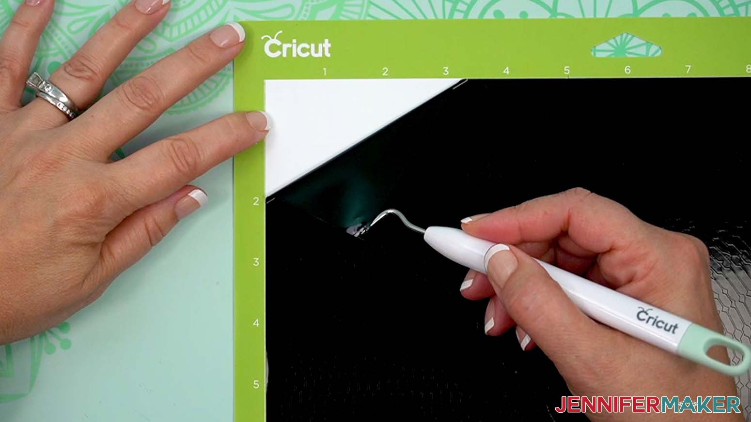 Use a weeding tool to pull vinyl away from backing at the corner of the mat.