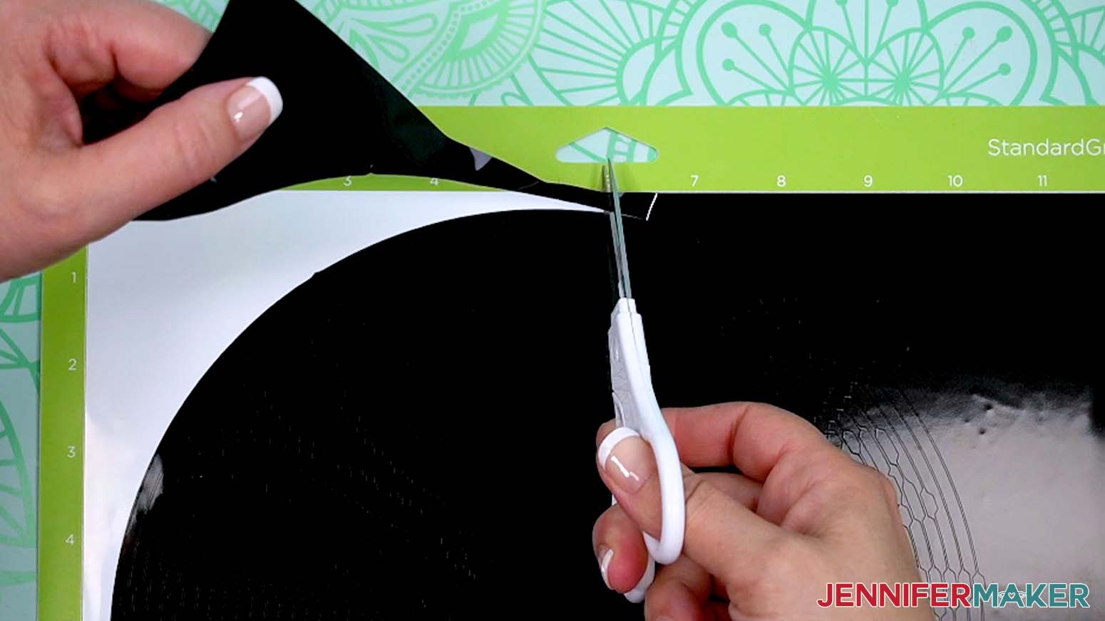 Use scissors to cut away the large background sections of vinyl