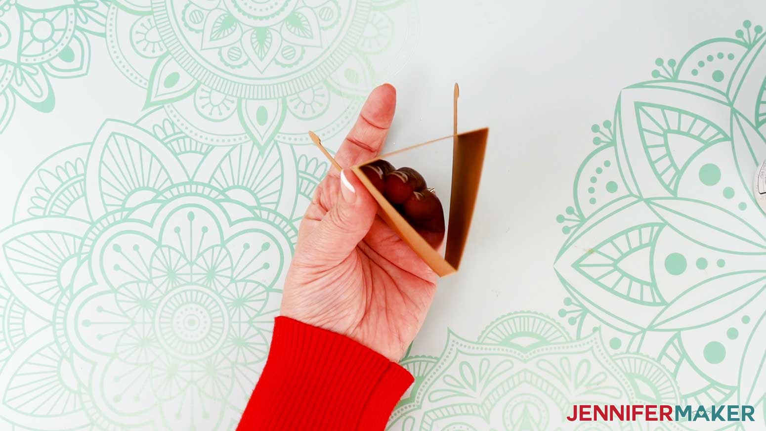 Fold the stand into a triangular tube and attach the glued edge to the inside of the last folded panel.