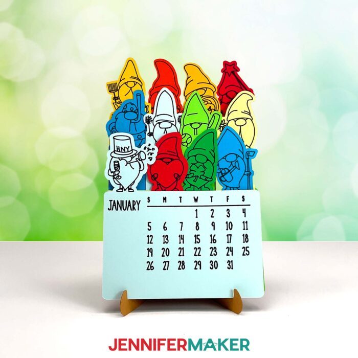 A Stacked Calendar featuring cute gnome drawings applied with Cricut pen sits on a sunny surface