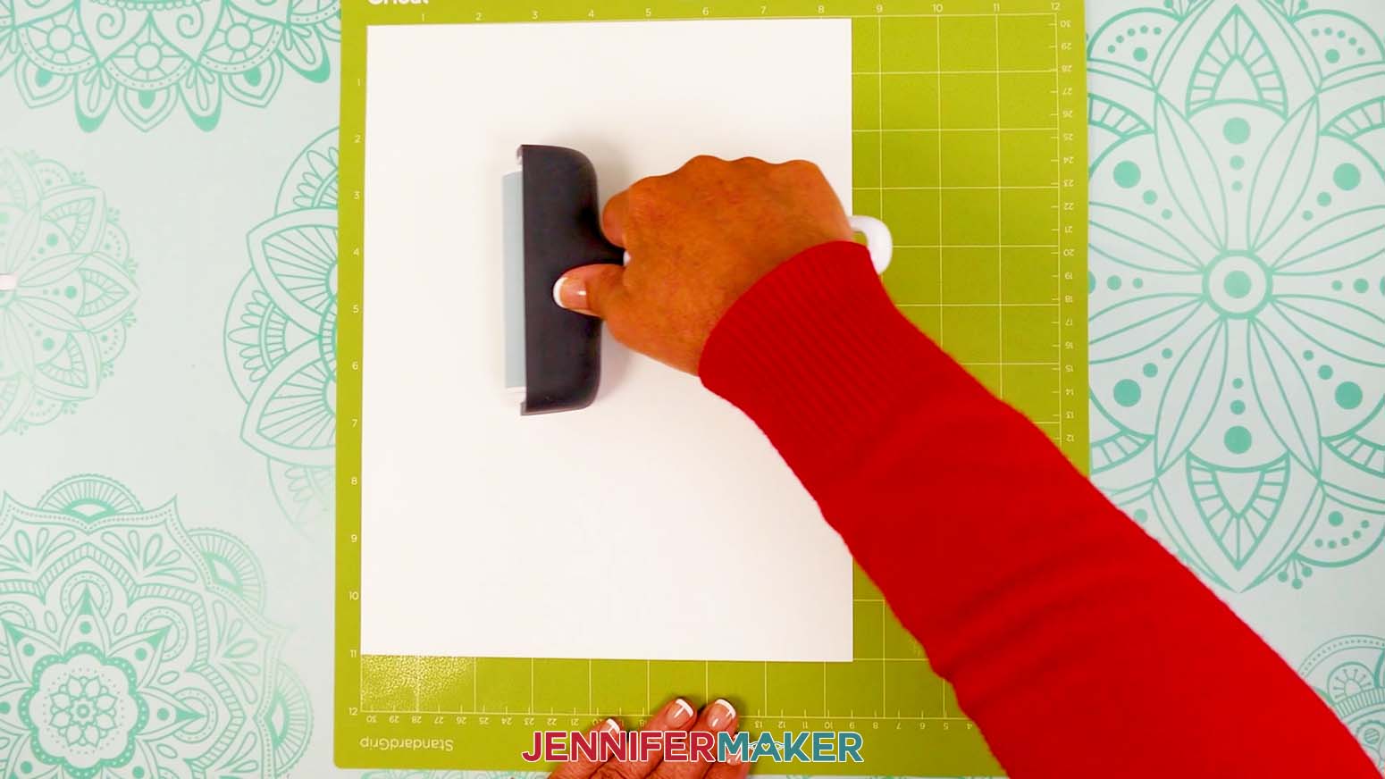 Use a brayer to securely place the heavy cardstock onto the Cricut machine mat for the stacked calendar stand.