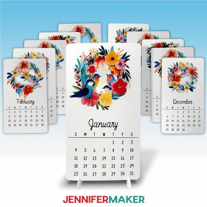 A printable stacked desk calendar with bird and flower artwork designed by Jennifer Maker sits on a cardstock stand with the January card in front, surrounded by month cards for February through December.