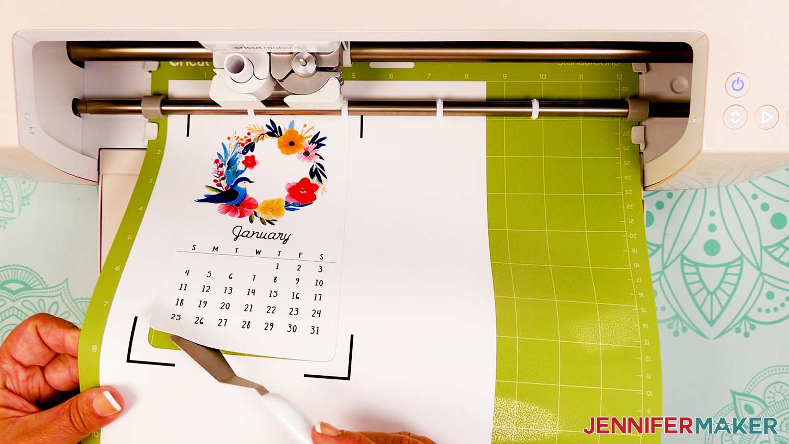 Before unloading the machine mat, use a spatula to gently lift the edge of the calendar card to verify it is cut completely through.