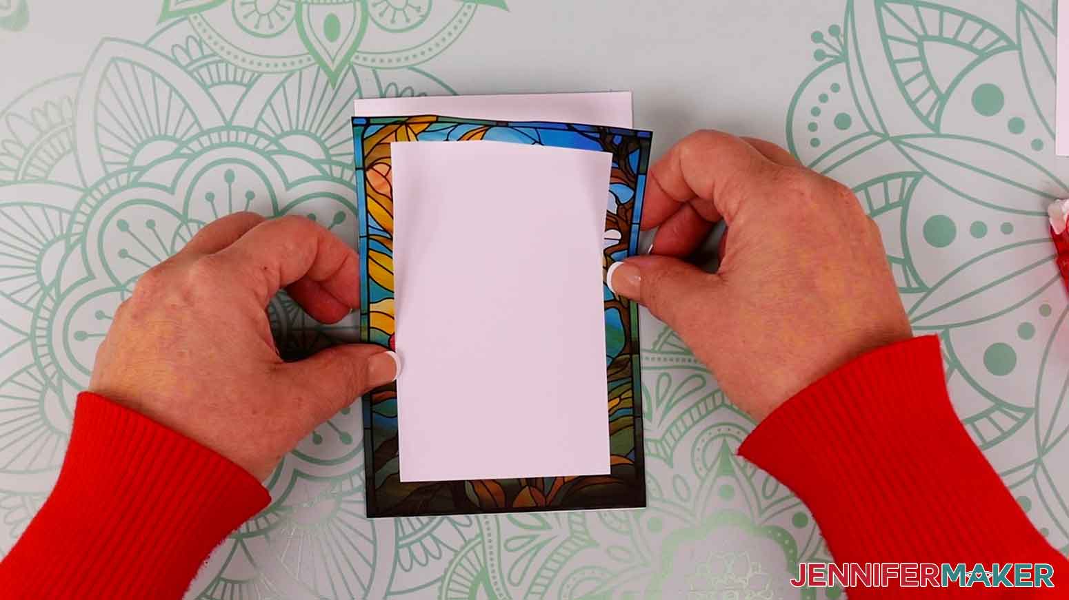 Align and press the largest flower border layer in to place on the rectangular white cardstock.