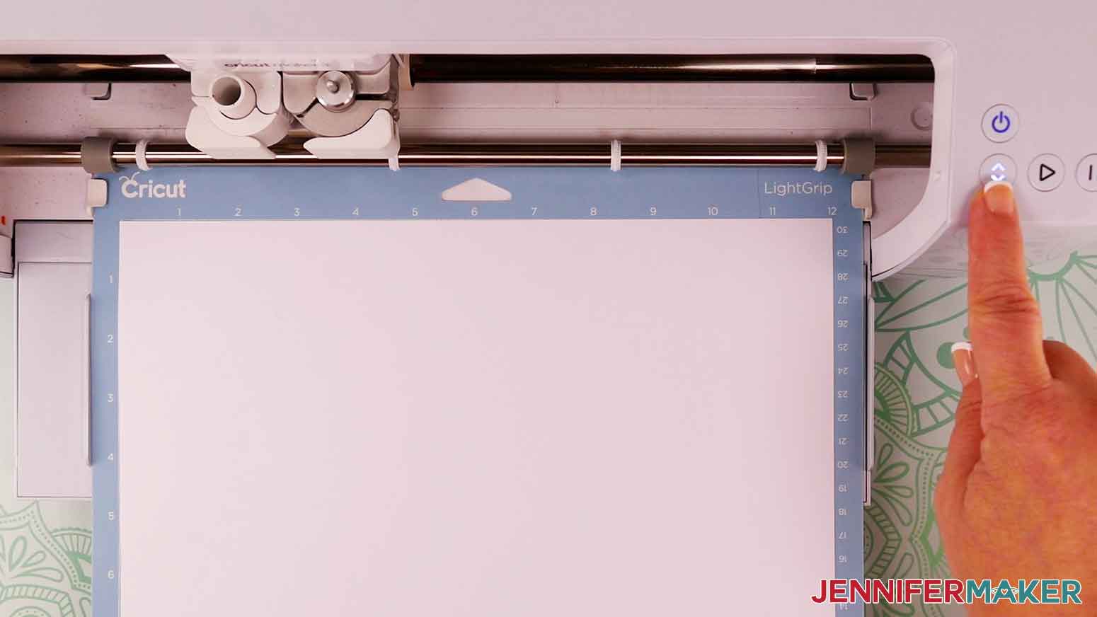 Place the cardstock on a sticky blue machine mat and press the flashing arrows to load it in to the Cricut.