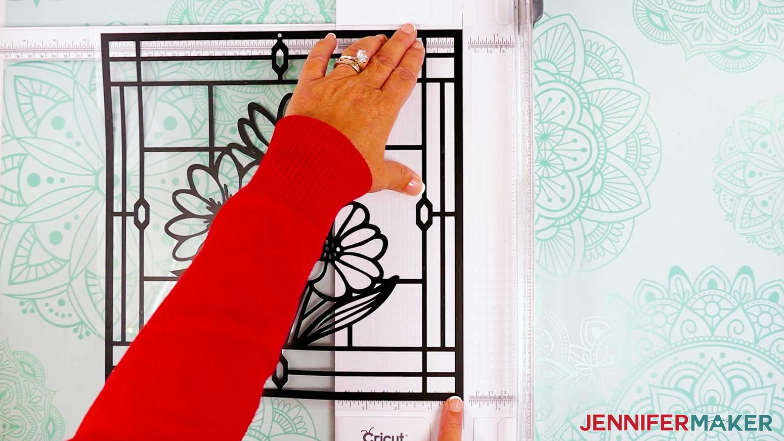 Trim the top acetate layer of the stained glass design to the outside edge of the applied vinyl.