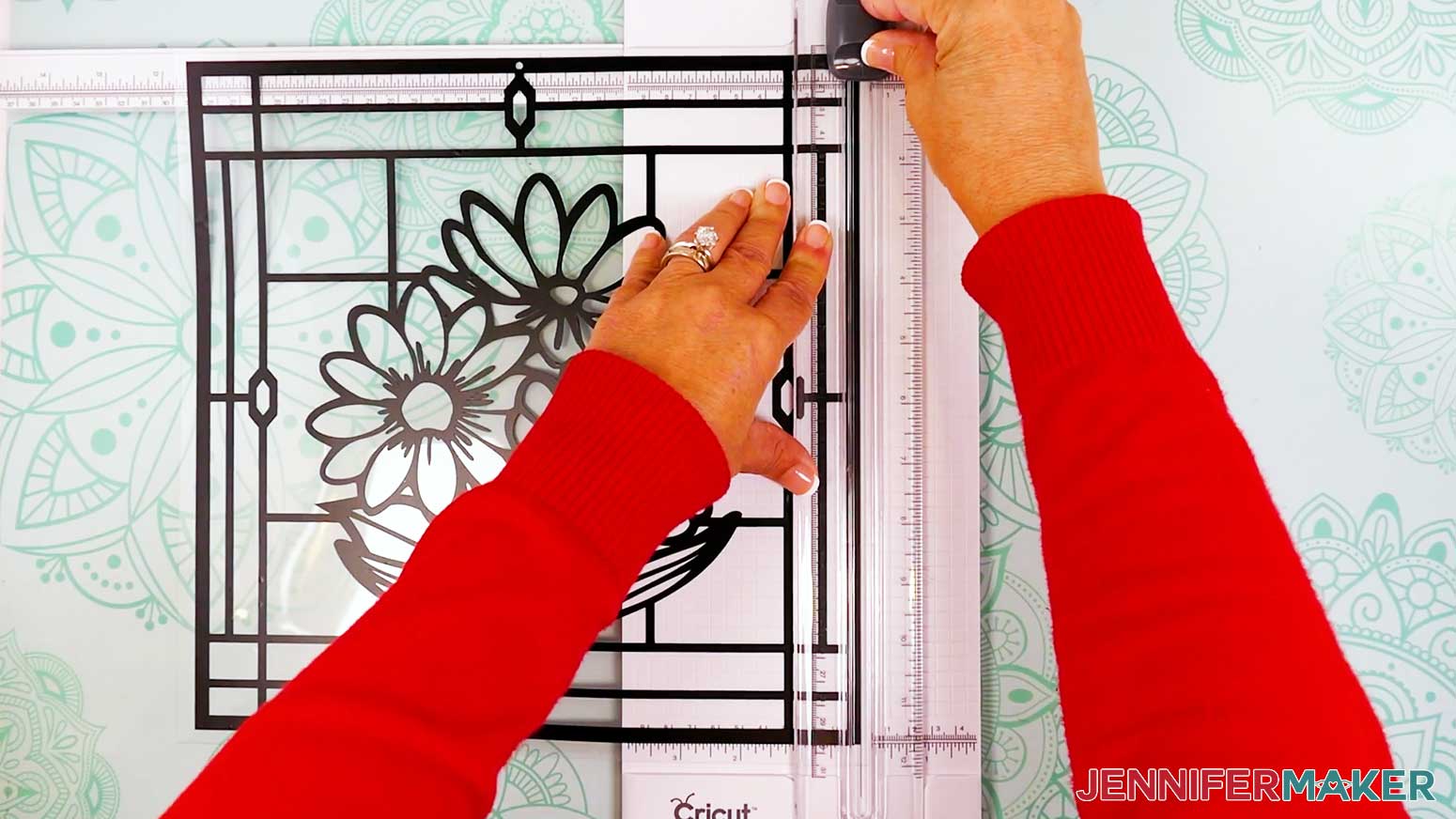 Hold the acetate layer of the stained glass design in place when cutting the edges.