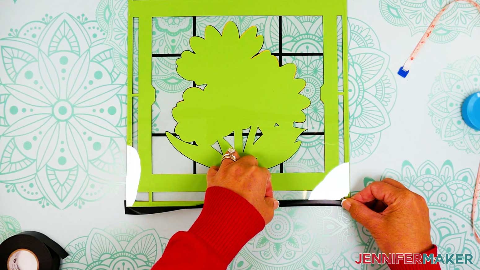 Fold the vinyl tape over to cover the side and back of the stacked layers of the stained glass design.