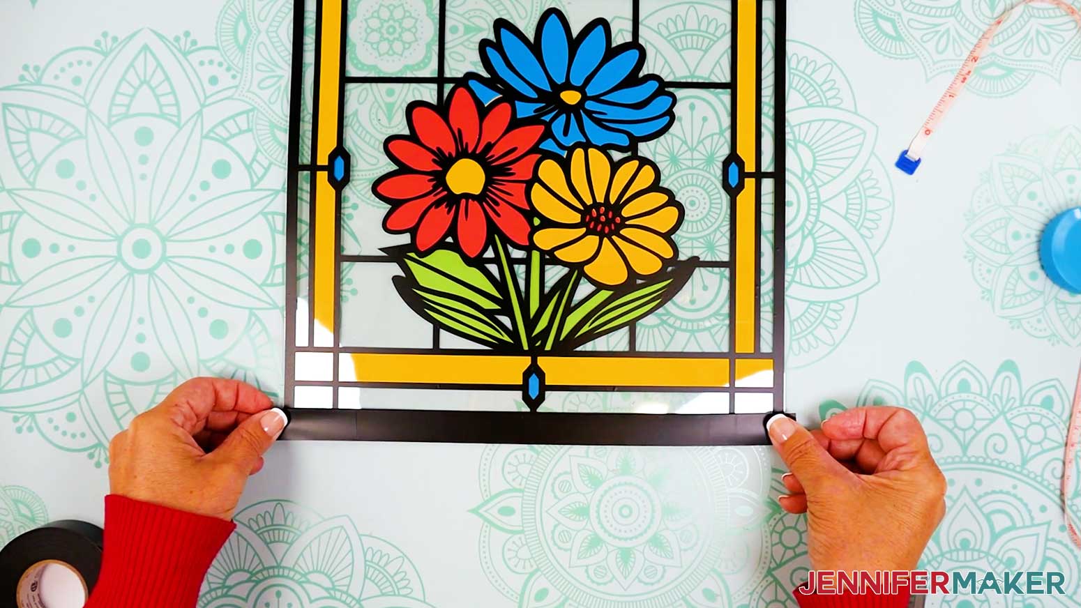 Apply black vinyl tape to the bottom edge of the stained glass design.