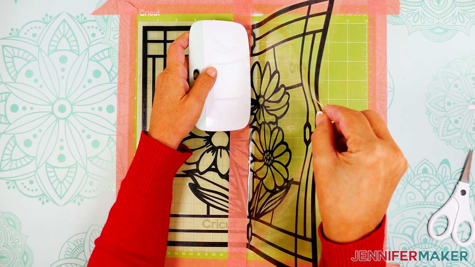 Use an extra large scraper to burnish the vinyl onto the acetate layer of the stained glass design.