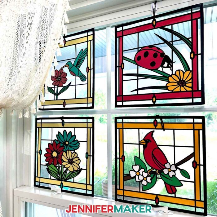 Make Stained Glass Using Paper! Four paper, acetate, and vinyl stained glass window-inspired crafts hang in a sunny window
